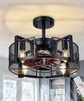 Black enclosed cage ceiling fan with light visible in a modern room, remote in hand. Product: Industrial Style Ceiling Fan With Light For Living Room And Bedroom Black Enclosed Cage Ceiling Fan With Remote Six Speeds Ultra Quiet Noiseless DC Motor 16 Inch Vintage Industrial Design For Your Pad