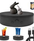 ComXim 4.53 Inch Black Rotating Display Stand Electric Turntable Spinning Platform showcasing decorative rabbits and drinks.