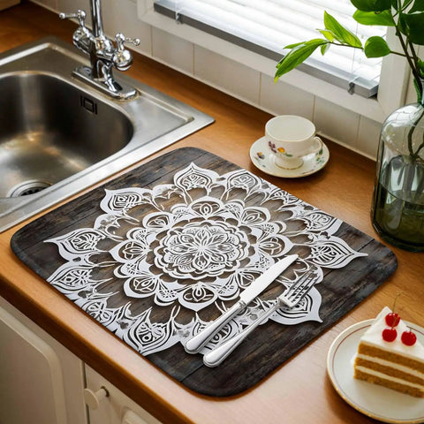 Dish Drying Mat With Abstract Flowers In White For Kitchen Counter Must Have Absorbent Microfiber Surface With Cushioned Drying Layer Machine Washable Vintage Wood Grain Look 16 By 18 Inches on countertop near sink.