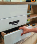Stealthy Recessed Zinc Alloy Door Handle 85mm Rotation Pull For Drawer Cabinet shown in use on a white drawer