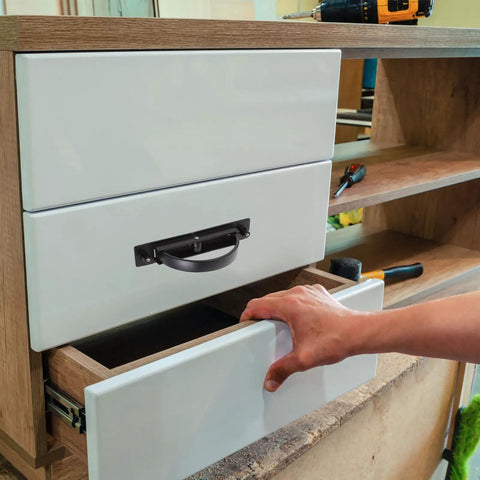 Stealthy Recessed Zinc Alloy Door Handle 85mm Rotation Pull For Drawer Cabinet shown in use on a white drawer