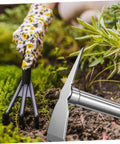 Rustproof Stainless Steel Garden Hoe Handheld Weeding Tool With Ergonomic Grip in use among green plants and soil