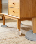 Two Pack Adjustable Furniture Legs With Height Adjustment And Non Slip Plastic Bases under wooden cabinet on rug
