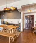 Modern kitchen with wooden tables and benches, lit by Vintage Edison LED Bulbs 6W Equivalent To 60W Warm White 2700K