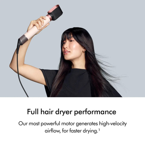Woman using Coanda 2x Airwrap Multi Styler And Dryer For Straight And Wavy Hair In Ceramic Pink, showcasing high air power.