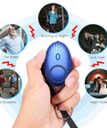 Hand holding blue personal alarm from Everyday Safety Keychain Set For Women And Kids With No Touch Door Opener Personal Alarm Whistle Pom Pom.