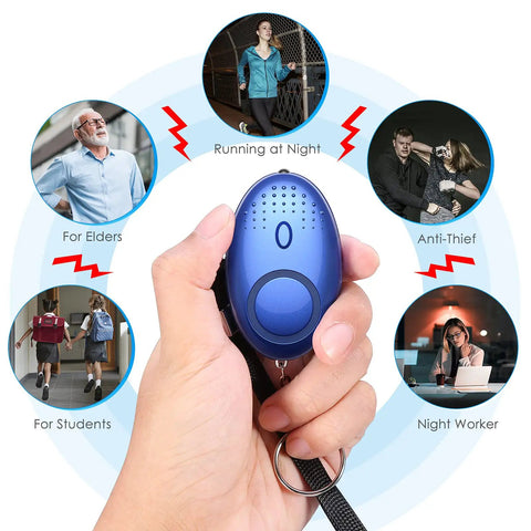 Hand holding blue personal alarm from Everyday Safety Keychain Set For Women And Kids With No Touch Door Opener Personal Alarm Whistle Pom Pom.
