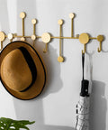 Snag Free Wall Mount Coat Hooks Built From Tough Wrought Iron With Funky Dot Designs And Relaxed Nordic Flair To Keep Your Daily Grind And Hallway Gear Tidy, mounted on wall with hat and umbrella.