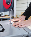 Close-up of hands operating the Shop Tough 5 Inch Metal Band Saw Featuring A Rock Solid 1.5 Hp Motor And Smooth Variable Speed Control.
