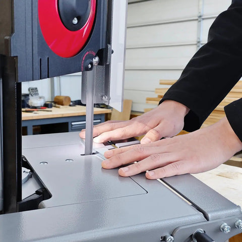Close-up of hands operating the Shop Tough 5 Inch Metal Band Saw Featuring A Rock Solid 1.5 Hp Motor And Smooth Variable Speed Control.