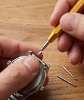 Person using Must Have Watch Band Repair Kit With 32 Stainless Steel Pins And A Spring Bar Tool Heavy Duty Replacement Kit For 12 26mm Straps