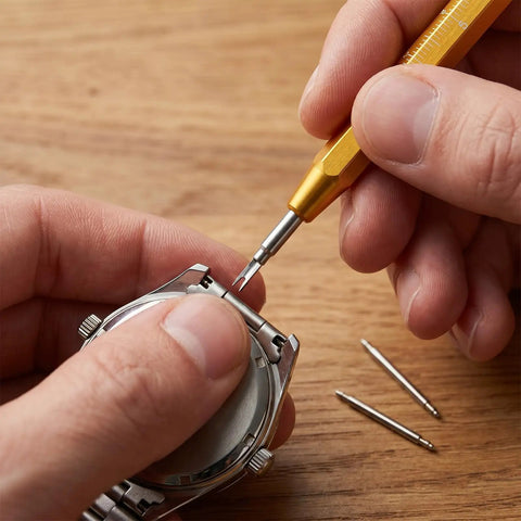 Person using Must Have Watch Band Repair Kit With 32 Stainless Steel Pins And A Spring Bar Tool Heavy Duty Replacement Kit For 12 26mm Straps