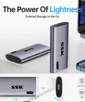 Image of a 256GB Portable SSD External Drive With Up To 550 MB Per Second USB 3.2 Gen2 For iPhone 15 Pro Windows Mac Android LED Indicator Trim And SMART Tech Ready next to a laptop.