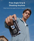 Person holding GoPro Hero 9 10 11 12 13 Street Grip Kit with metal rabbit cage and seesaw design, sky in background.