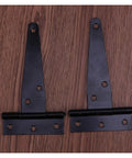Close-up of Heavy Duty Black Flat T Hinge Set for Barn Doors on wooden surface, corrosion resistant, 12 pack