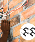 Installation of 100 Pack 25Mm Half Clamp Fixtures With Steel Nails For Cable Management on brick wall, close-up view