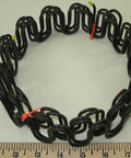 Heavy Duty 9 Gauge Zig Zag Sinuous Springs For Furniture And Auto Upholstery 10 Foot Roll displayed on a ruler for size reference.