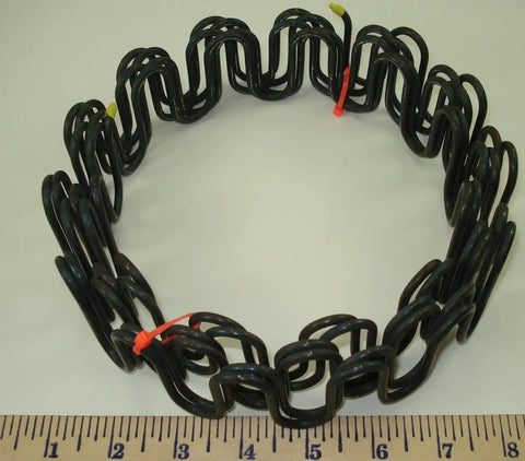 Heavy Duty 9 Gauge Zig Zag Sinuous Springs For Furniture And Auto Upholstery 10 Foot Roll displayed on a ruler for size reference.