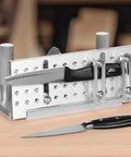 Rugged Adjustable Belt Sander Knife Jig With Dual Handles 85 To 115 Degrees Angle Finder on a wooden table showcasing precision knife sharpening.