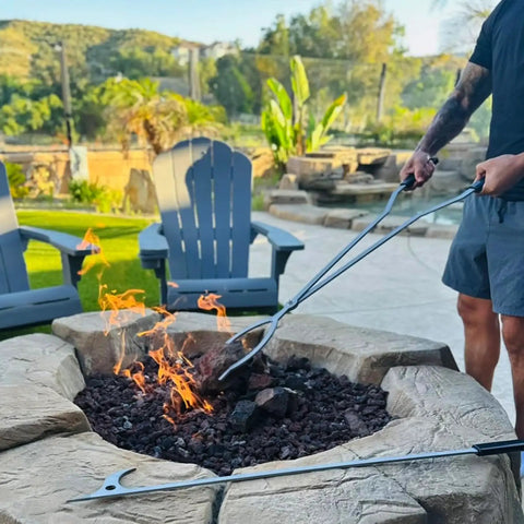 Person using 40 Inch Stainless Steel Fire Tongs And Poker Set For Outdoor Fire Pit Bonfire Campfire Backyard Deck And Indoor Fireplace Use