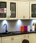 Clear The Counter Clutter With This Slick Wooden Acrylic Display Shelf in a modern kitchen setup with colorful decor.