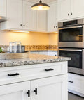 Modern kitchen with Ten Pack Matte Black Cabinet Knobs Square T Bar Dresser Knobs for Cabinets on white drawers