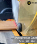Delmar Tools miter saw laser guide installed on saw projecting red laser line onto wood.