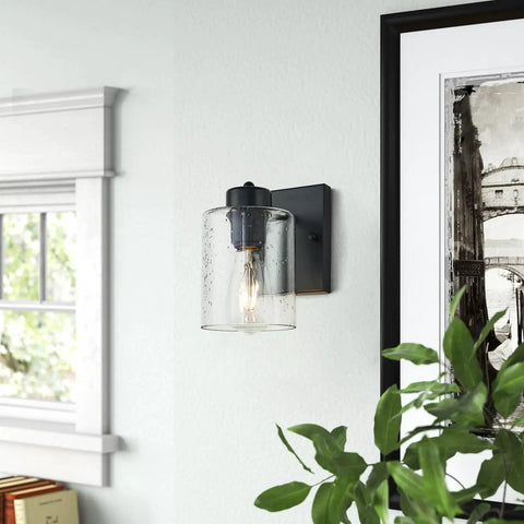 Set Of Two Matte Black Wall Sconces With Clear Glass Shade in modern room setting, industrial farmhouse vanity lighting seen on wall