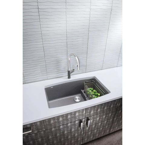 Modern kitchen sink with vegetables, wave-patterned backsplash, and sleek faucet