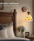 BZXNC Indoor Wall Sconce Lamp, Vintage 12.20" Copper, Compact Structure, glowing brass lamp with colorful glass shade above a bed.
