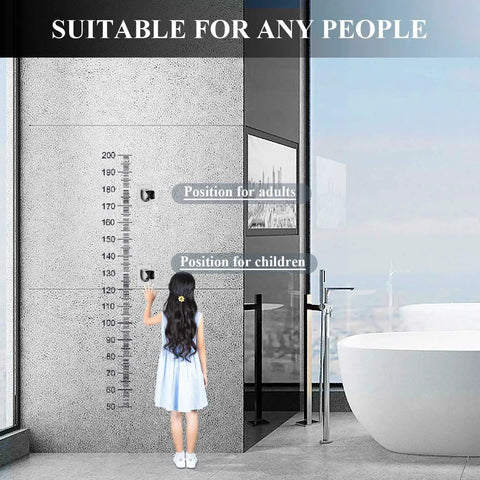 Child adjusting no drill shower head holder on bathroom wall next to height chart, demonstrating easy install and adjustability