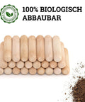 Stack of dowel pins one quarter inch by one and a half inch fluted hardwood pegs with soil, showing biodegradable label.