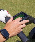 User interacting with touchscreen GPS on Remote Control Electric Golf Cart That Eats Up Fairways With 40000 Preloaded GPS Tracks.