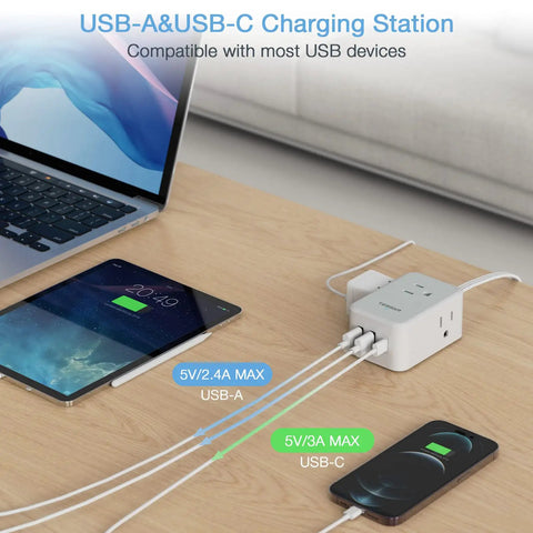 Ultra Slim Flat Plug Power Strip With USB Ports, Five Foot Extension Cord, charging devices on table next to laptop