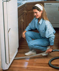 Long Reach Vacuum Extension Attachment With 36 Inch Reach And Flat Hose Design For Deep Cleaning Dust Bunnies, Pet Hair, And Hard-To-Reach Spots Under Furniture And Fridge, Gray Finish in use under a fridge.