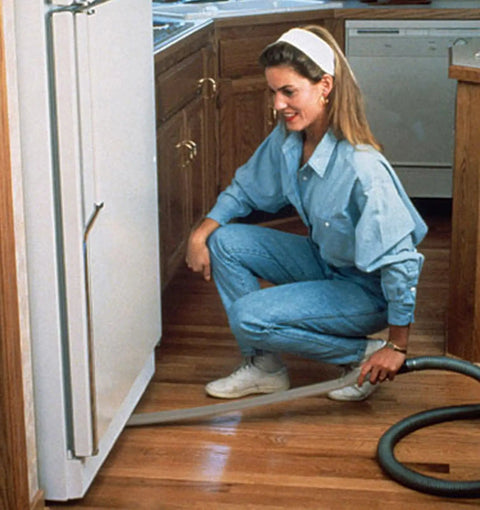 Long Reach Vacuum Extension Attachment With 36 Inch Reach And Flat Hose Design For Deep Cleaning Dust Bunnies, Pet Hair, And Hard-To-Reach Spots Under Furniture And Fridge, Gray Finish in use under a fridge.