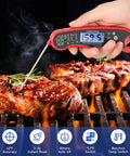 Digital Meat Thermometer for Cooking and Grilling with Instant Read, Waterproof Foldable Probe, held over steak on grill, red