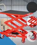Premium Garvee Double Scissor Hydraulic Lift Table Cart, 330 Lbs Capacity, Red with black surface and red scissor legs in a warehouse.
