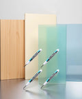 Heavy Hitter White Oil Based Permanent Markers Pro Grade Industrial Pens For Metal Glass And Hard Surfaces Fast Dry Paint Marker Set With Fine Tips For Workshop Jobs And Weekend Builds on wood and glass backgrounds.