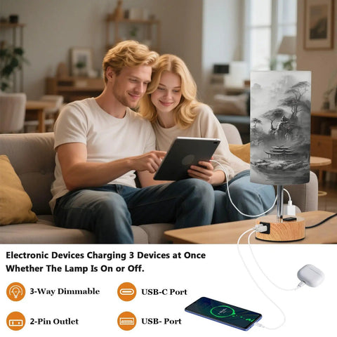 Couple using tablet next to Mountain Watercolor Bedside Table Lamp With 3-Way Dimmable Touch Control And Built-In Charging Station