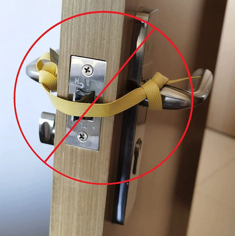 Image showing a door handle improperly secured with a yellow strap, illustrating ineffective door lockdown without Six Pack Magnetic Lockdown Strips For Iron Door Frames With High Density Magnets, No Brainer Emergency Lockdown Solution For Schools And Offices, Durable PVC Surface, Reusable And Quick Install, Yellow.