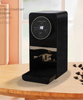 Kick Start Your Morning Routine With This Automatic Coffee Tamper Built As A Smooth Operator For 58MM Portafilters Featuring Adjustable 5 To 30KG Pressure Tough Stainless Steel Body And Zero Sweat Cleaning For Legit Barista Vibes All Day Black on a wooden counter with coffee beans.