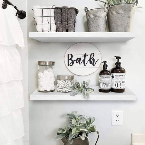 Floating Wall Shelves Set Of 2 23.6 x 9.3 Inches White MDF With Steel Brackets displaying plants and bath items in bathroom decor.