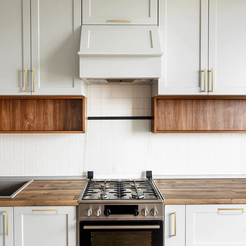 5 Pack Solid Brass Cabinet Pulls With Six And A Quarter Inch Hole Centers in Brushed Matte Gold on white kitchen cabinets