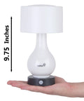 Person holding a 9.75-inch Six LED Battery Operated Motion Sensing Table Lamp With Dual Zone Lighting for size reference