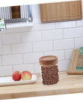 Keep Coffee Beans Fresh As Heck With This Solid 3 Piece Airtight Glass Canister Set Designed For Loose Tea And Spices Compact Footprint Saves Counter Space And Locks In Flavor Straight Up, showcasing a jar filled with coffee beans on a kitchen counter.