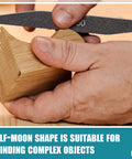 Sanding sticks for model making - close-up of hand using a black grit sanding stick on a wooden block