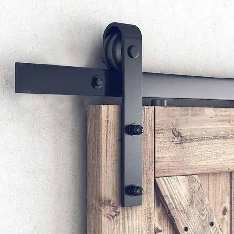 Close-up of Top Tier Carbon Steel Barn Door Hardware Kit Heavy Duty Sliding Track System Rock Solid Matte Black Rail.