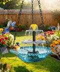 Solar Cascade Hanging Bird Bath Fountain With 3 Layer Design For Outdoor Gardens And Ponds 6 Nozzles And 10 Ft Cord Solar Powered Pump Attracts Hummingbirds No Wiring Needed in a blooming garden with birds flying around.