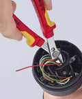 Insulated 5 Inch Diagonal Cutting Pliers With 1000V VDE Rating cutting wires in an electrical component, flush cut precision visible.